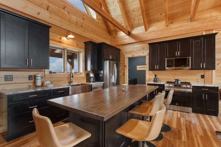 Kitchen includes Stainless Appliances, Granite Counter Tops and a Custom Wood Toped Center Island with Seating