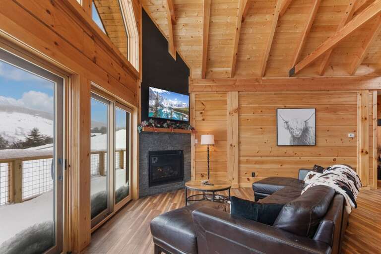Living Room with TV, Gas Log Fireplace and Main Level Deck