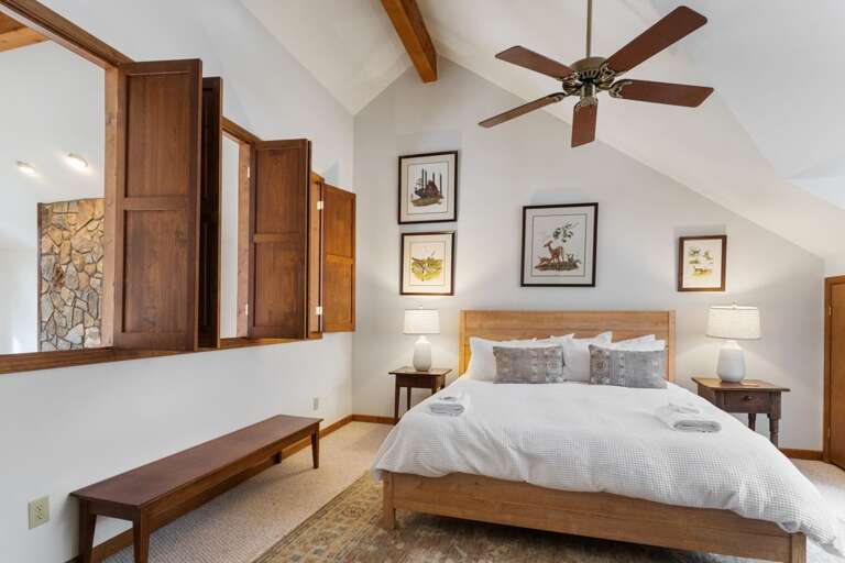 Top Floor Bedroom with King Bed, Vaulted Ceiling, and Windows That Open to the Great Room