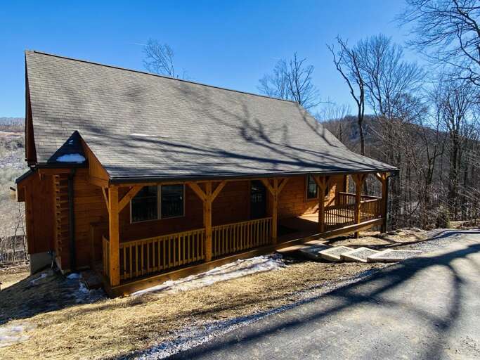 Cozy Rustic Cabin is Accessed Via a Short, Steep, Paved Driveway. There are 4 Steps Down to the Front Porch