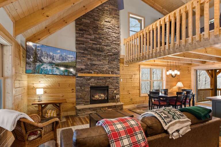 Living Room with Rock Gas Fireplace and TV