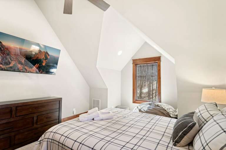 Queen Bed and TV in Guest Bedroom One