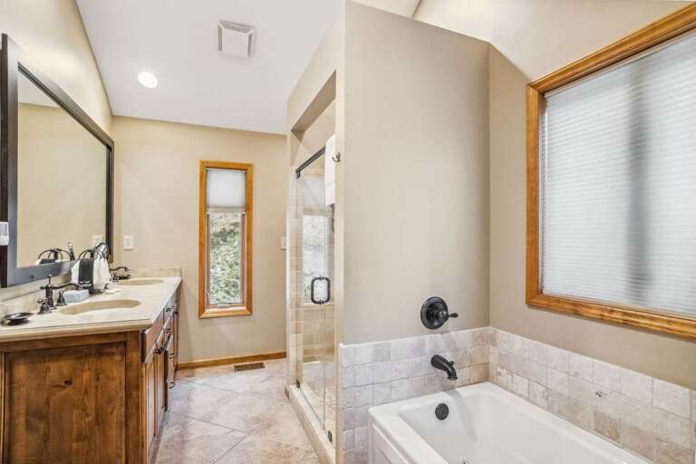 Master Bathroom with Jacuzzi Tub, Step-In Shower, and Double Vanities