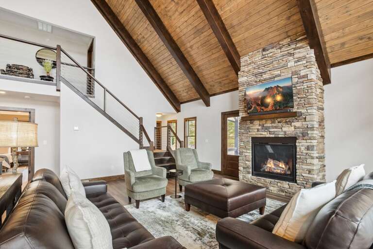 Leather Furniture in the Living Room with TV and Stacked Stone Gas Fireplace