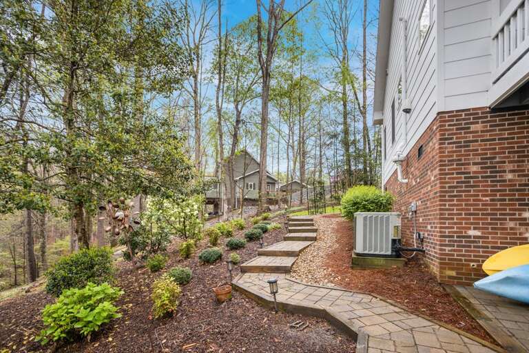Manicured Landscaping and Stone Path Around the House