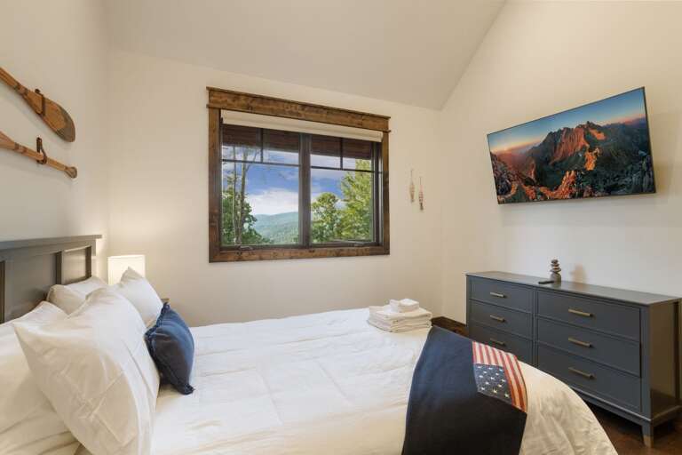 Main Floor Queen Bedroom has a TV and Private Bathroom