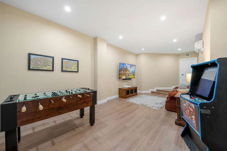 Lower Level Game Room with Foosball Table, Multi-Cade Arcade Game, Big Screen TV, and Sleeper Sofa