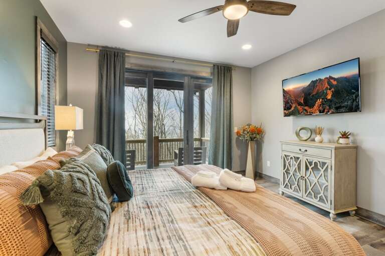 King Bed, TV, Private Bathroom, and Deck Access in the Master Bedroom