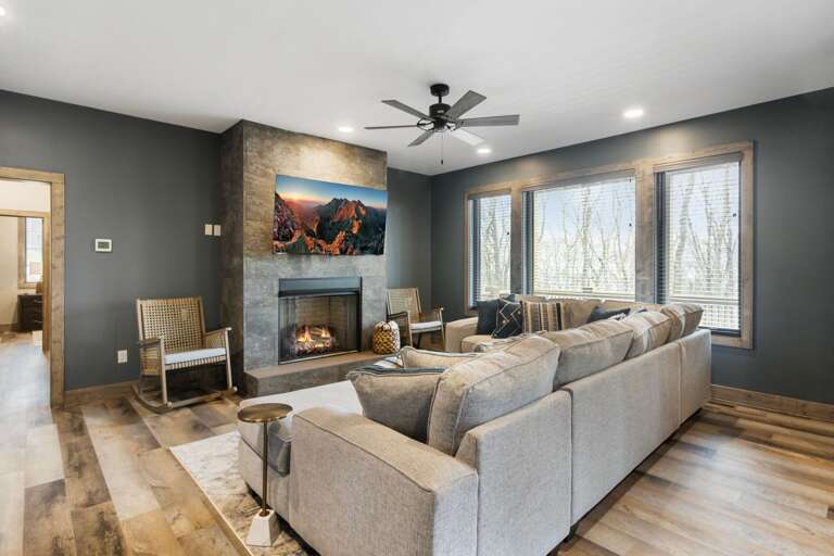 Lower Level Family Game Room with Comfortable Sofa, TV, and Gas Log Fireplace