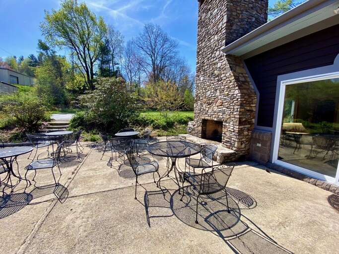 Common Area at the Club House with Outdoor Seating and Stacked Stone Wood Burning Fireplace