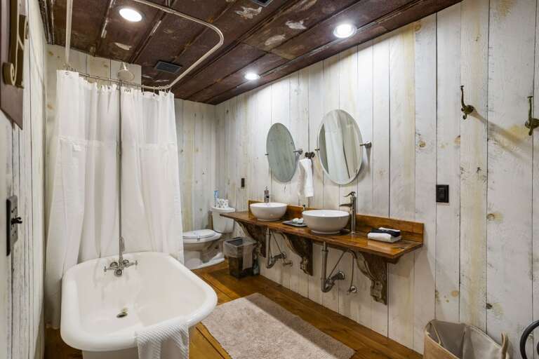 Lower Level Bathroom with Claw Foot Tub with Shower Surround and Double Vanities Lower Level Bathroom with Claw Foot Tub with Shower Surround and Double Vanities