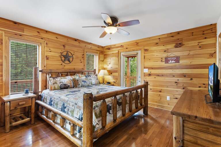 Main Floor Master Bedroom with King Bed, Deck Access, and Private Ensuite