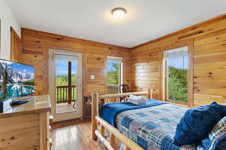 Main Floor Queen Bedroom with Deck Access and TV