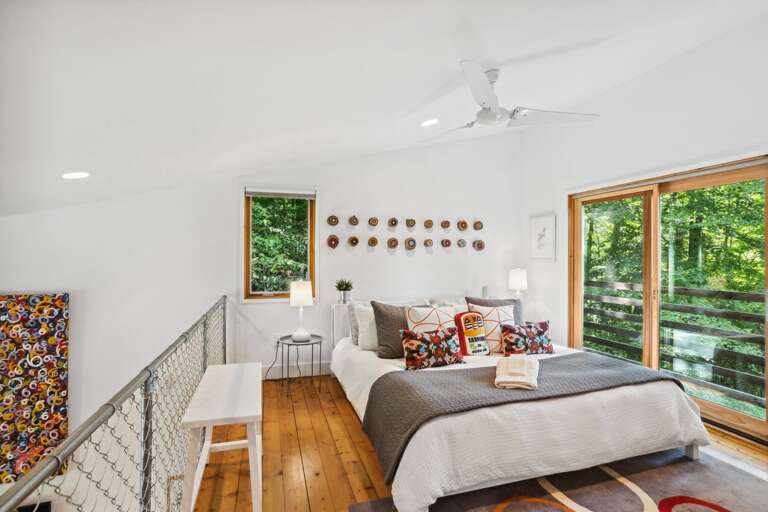 Loft Bedroom with Sliding Glass Doors that Let in Natural Light and Cool Mountain Air