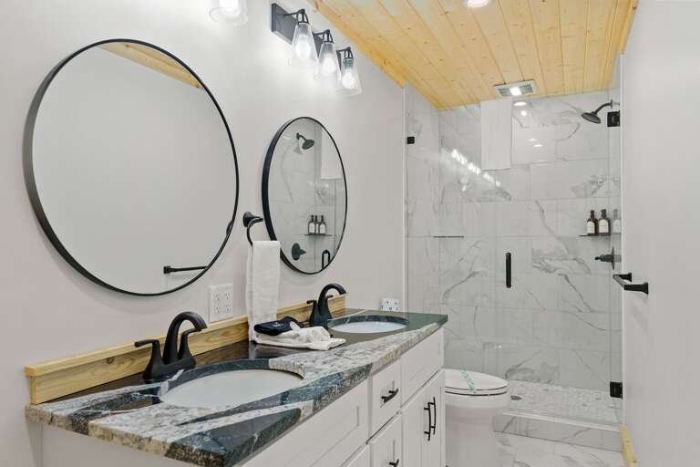 Lower Level Full Bathroom with Double Vanity and Step In Shower