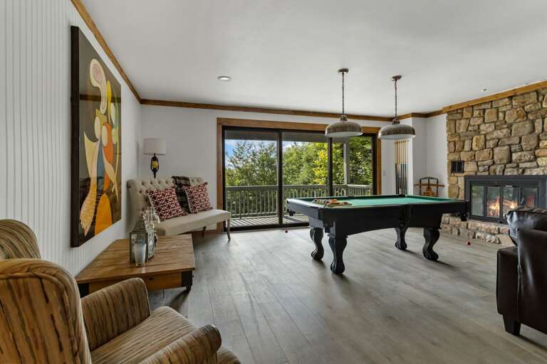 Lower Level Game Room with Pool Table, Gas Fireplace, and Deck Access