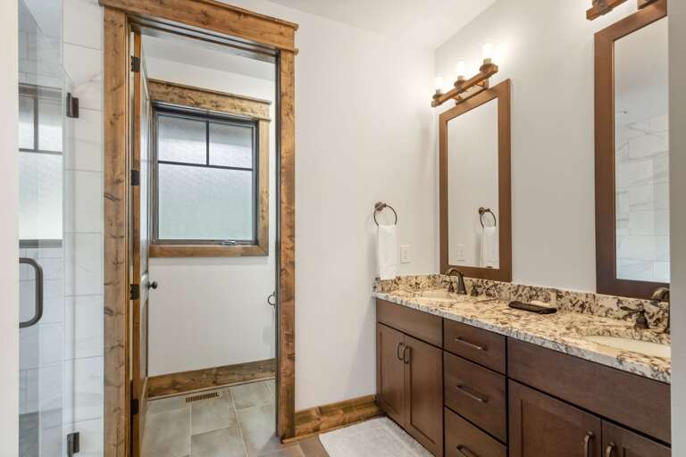 Master Bathroom has a Tiled Step-In Shower, Dual Vanity Counter and Separate Water Room