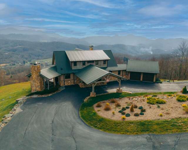 Aerial View Of A Scenic Stone-front Vacation Rental Surrounded By Sweeping Landscapes