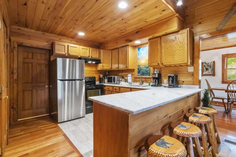 Bright Kitchen with Bar Seating Adjacent to the Dining Room