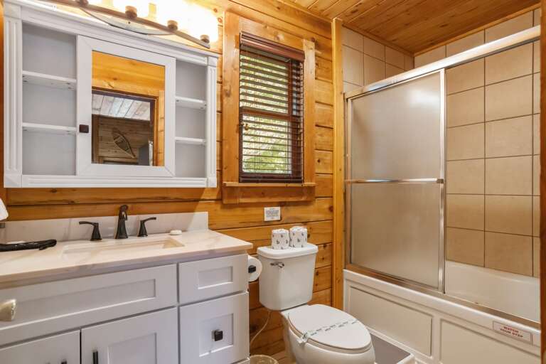 Main Floor Bathroom with Glass Door Tub and Shower Combo