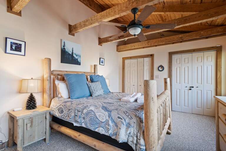 Exposed Beam Ceiling and Comfortable Queen Bedroom