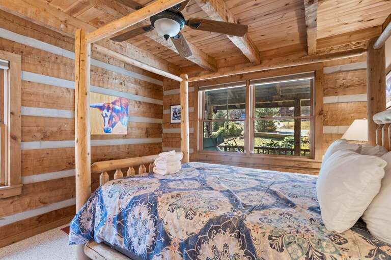 Exposed Beam Ceiling with Four Poster Queen Bed