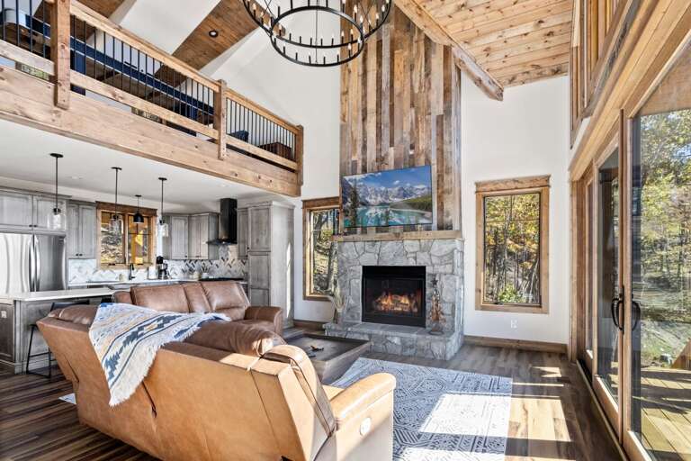 Leather Reclining Sofas, Stacked Stone Gas Fire Place and Wood Accents in the Living Room