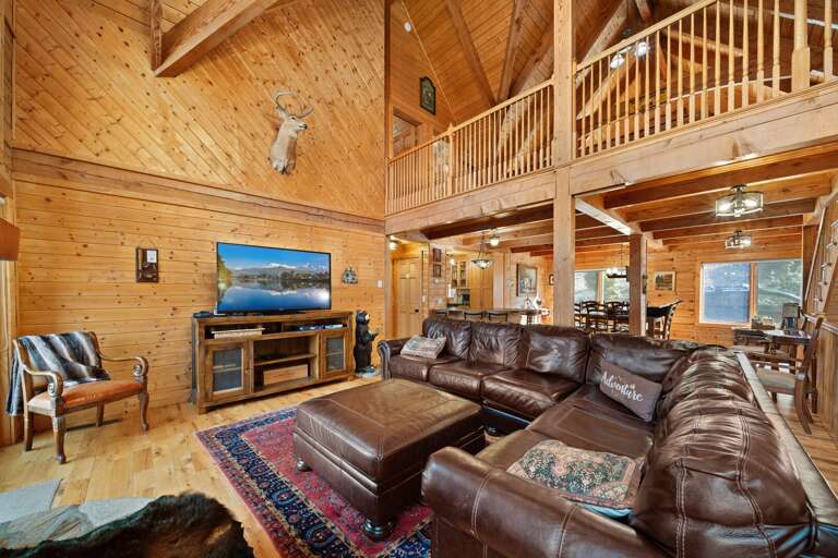 Leather Sofa, TV, and Exposed Beam Vaulted Ceiling