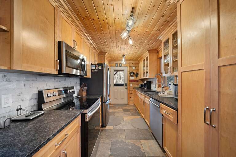 Spacious Kitchen with Tile Flooring, Granite Counters and Stainless Appliances