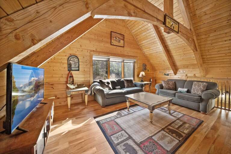 TV and Comfortable Love Sofas in the Loft with a Queen Pull-Out