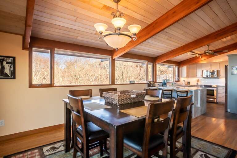 Wood-lined Dining Space With Views, Seamlessly Sliding Into Kitchen Area