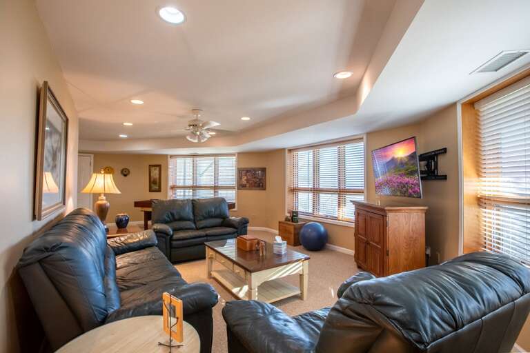 Lower Level Family Room with Game Table, TV and Comfy Leather Seating