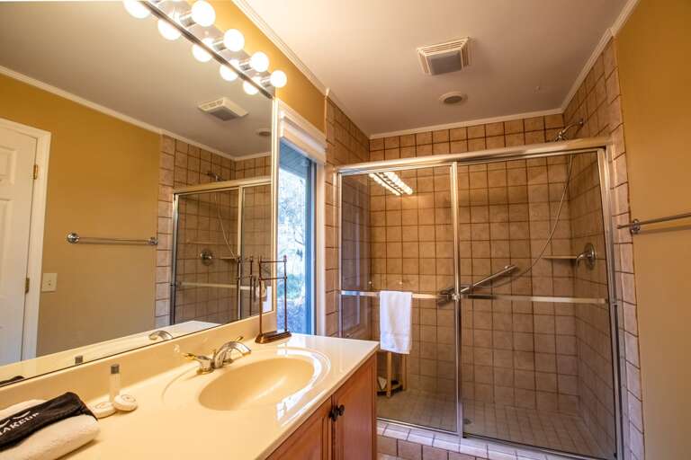 Main Level King Bedroom Ensuite Bathroom with Tiled Step In Shower