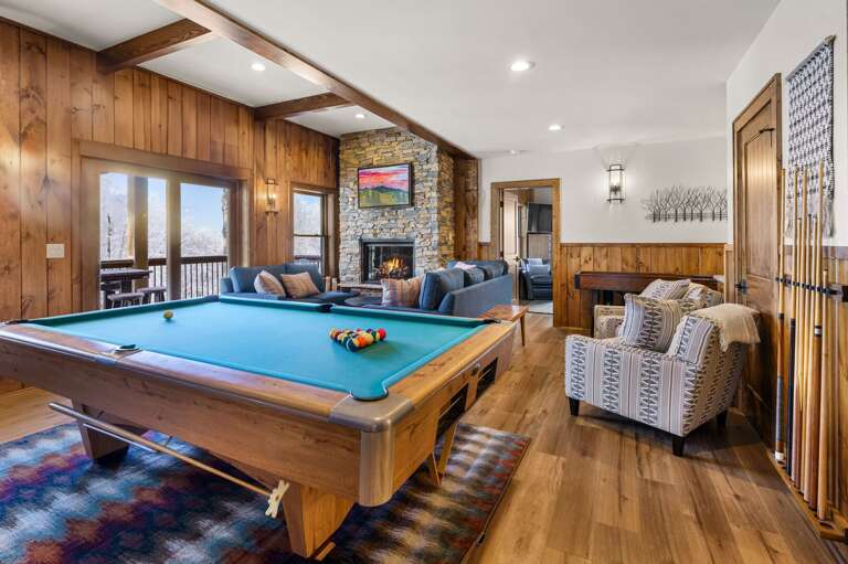 Lower Level Has a Pool Table, Stacked Stone Fireplace and Seating