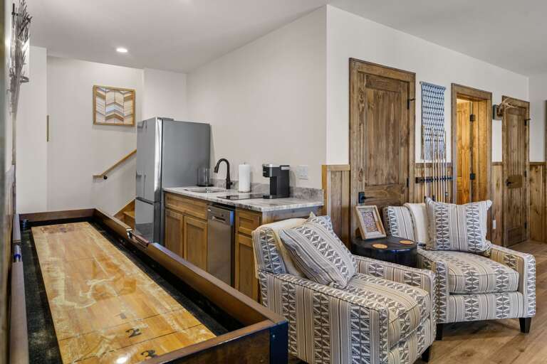 Mini Kitchen and Shuffleboard Table in the Lower Level Living Room, also has a Pool Table