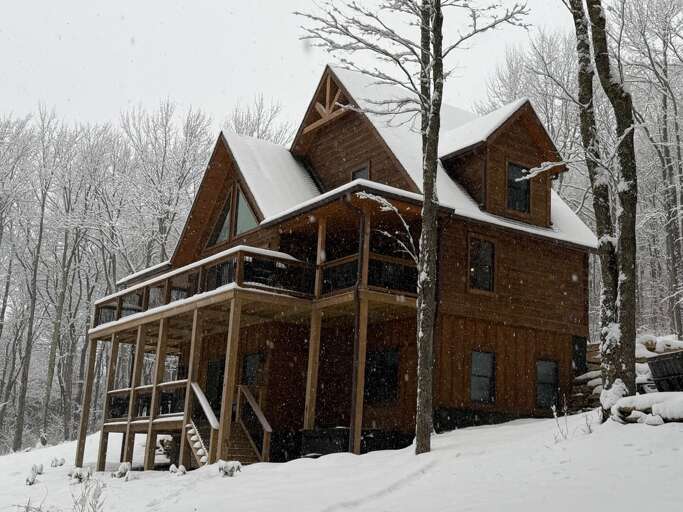 Winter Woodland Cabin Covered In Snow