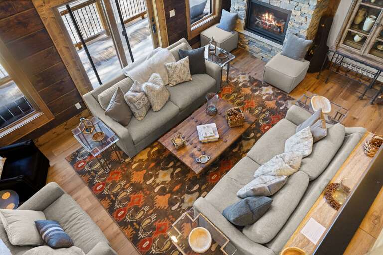 View from the Loft to Living Room with Fireplace, Deck Access and Cozy Seating