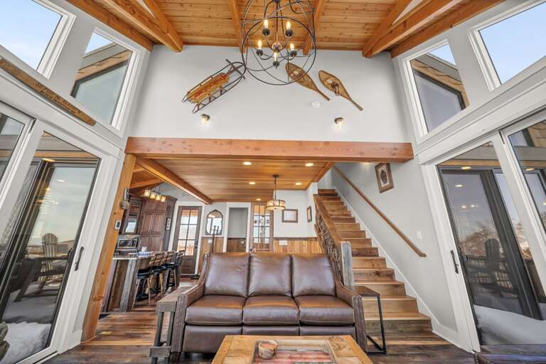 Living Room Flanked with Windows, Wood Floors and Ceiling and Ambient Lighting