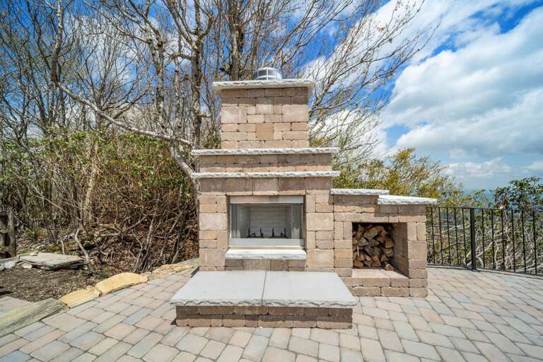 Outdoor Stone Fireplace on the Stone Patio Outside Straight Up Apartment