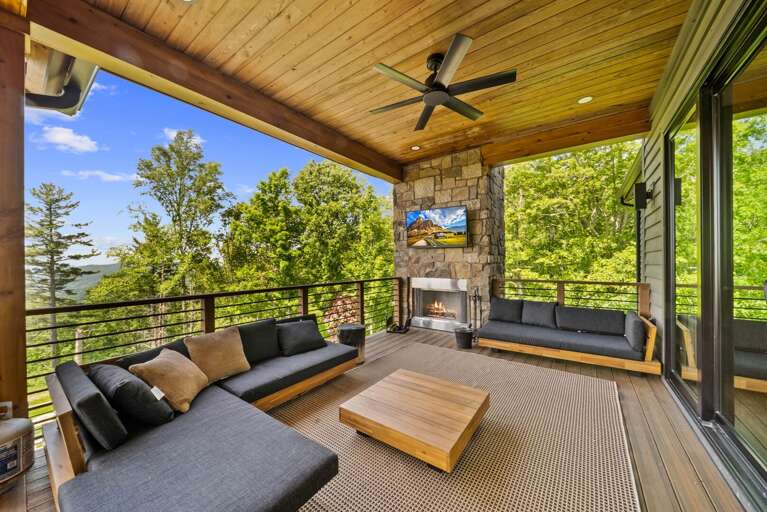 Outdoor Covered Living Area with Wood Burning Fireplace, TV and Sleek Seating