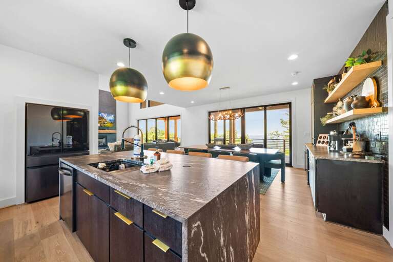 Sleek Refrigerator, Beautiful Lighting and Open Concept Space