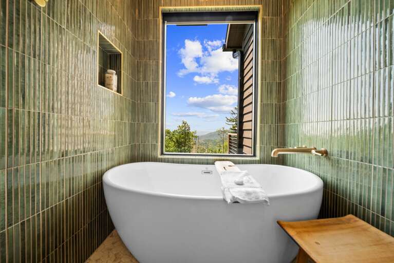 Soaking Tub within the Huge Tiled Shower with a Mountain View