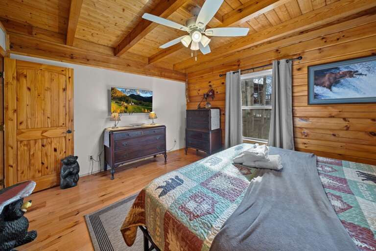 TV and King Bed with Classic Mountain Decor