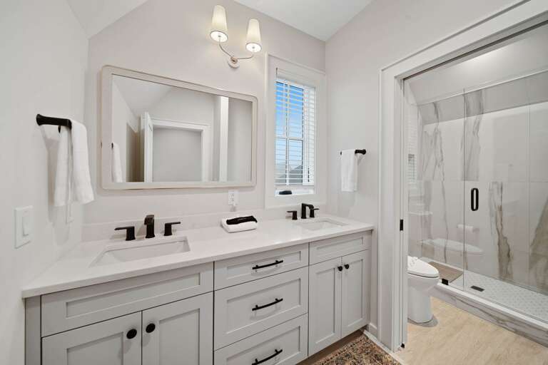Ensuite Bathroom with Tiled Shower and Dual Sink Vanity
