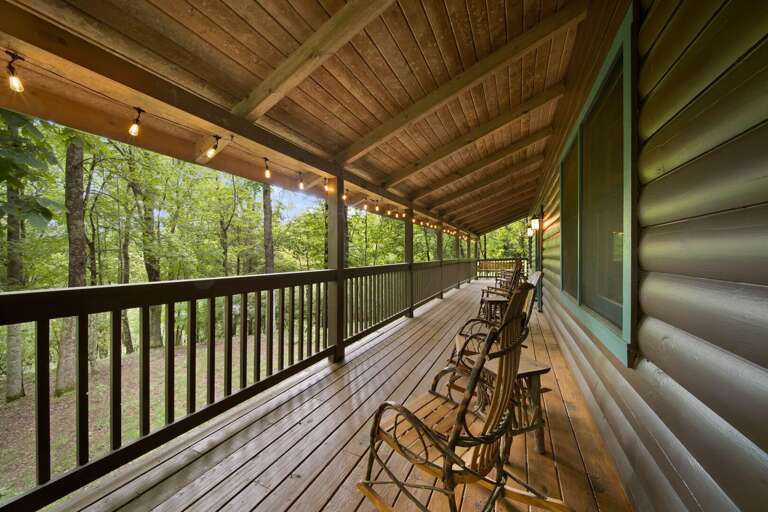 Enjoy the Wooded Setting Year Round on the Covered Deck with Accent Lighting