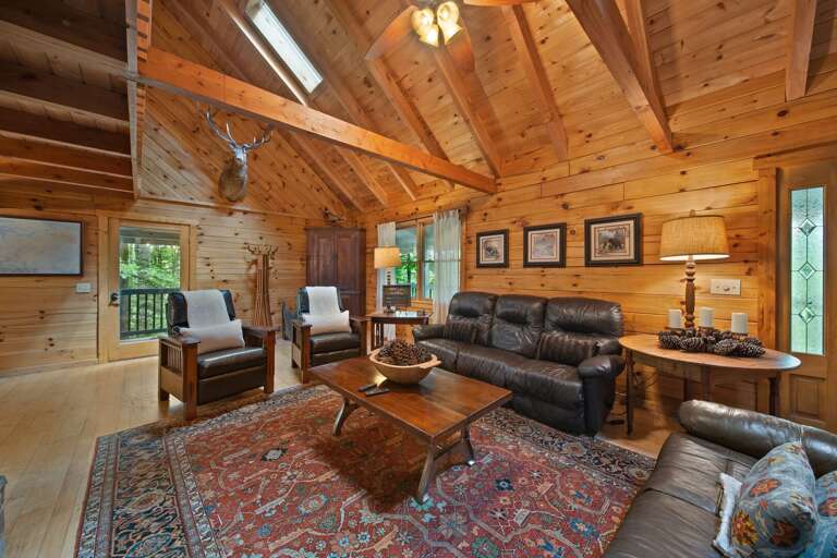 Leather Furniture, Vaulted Exposed Beams, Skylights and Floor to Ceiling Wood Interior
