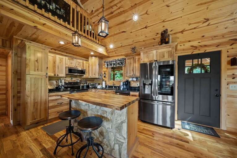 Kitchen with Wood Top Island and Stone Knee Wall