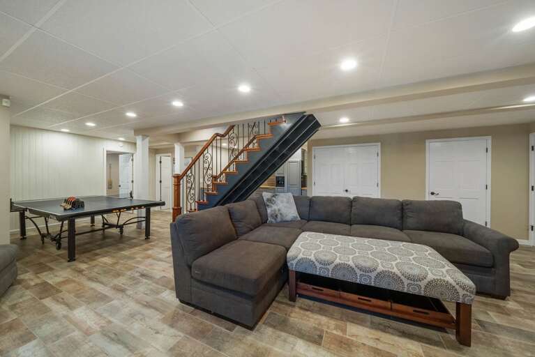 Lower Level Family Room with Plush Sectional and Ping Pong Table