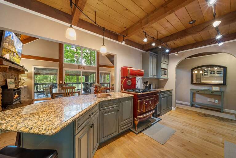 Spacious Kitchen Adjacent to Living Room with TV and Gas Fireplace