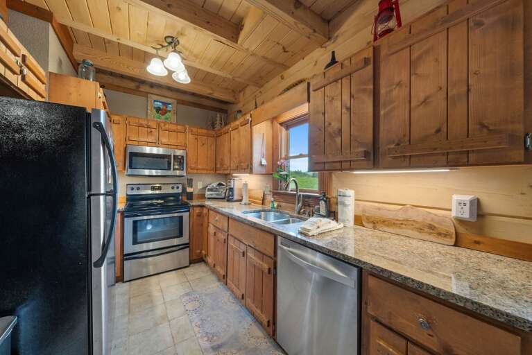 Kitchen has Granite Counters and Stainless Appliances